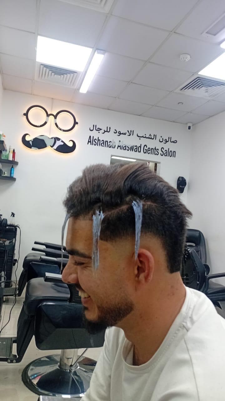 Hair color process inside Alshanab Al Aswad Gents Salon