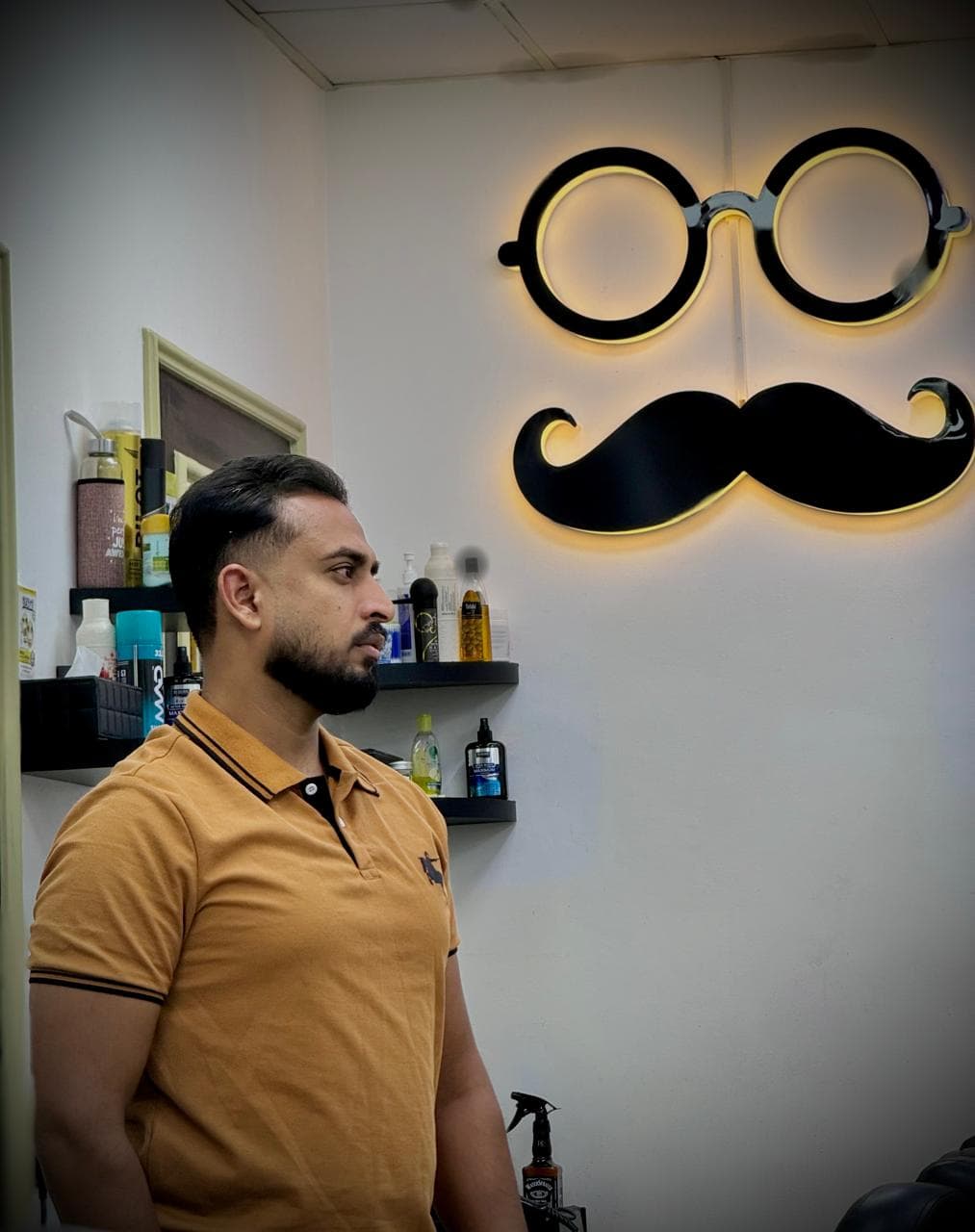 Salon wall logo with customer after haircut